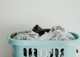 white textile on blue plastic laundry basket