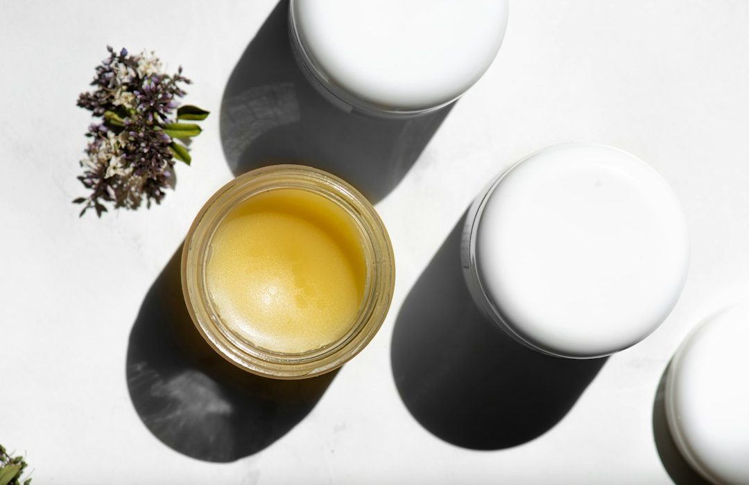 white pillar candle beside green plant