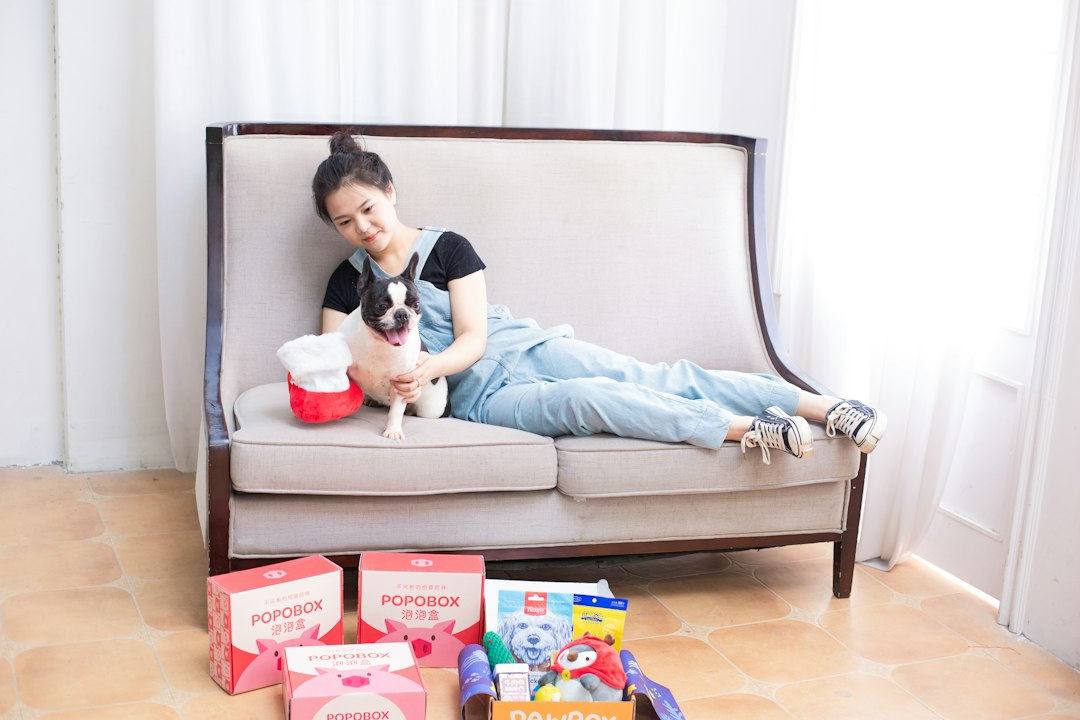 Woman and dog relax on a sofa with gifts