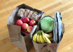 apples and bananas in brown cardboard box