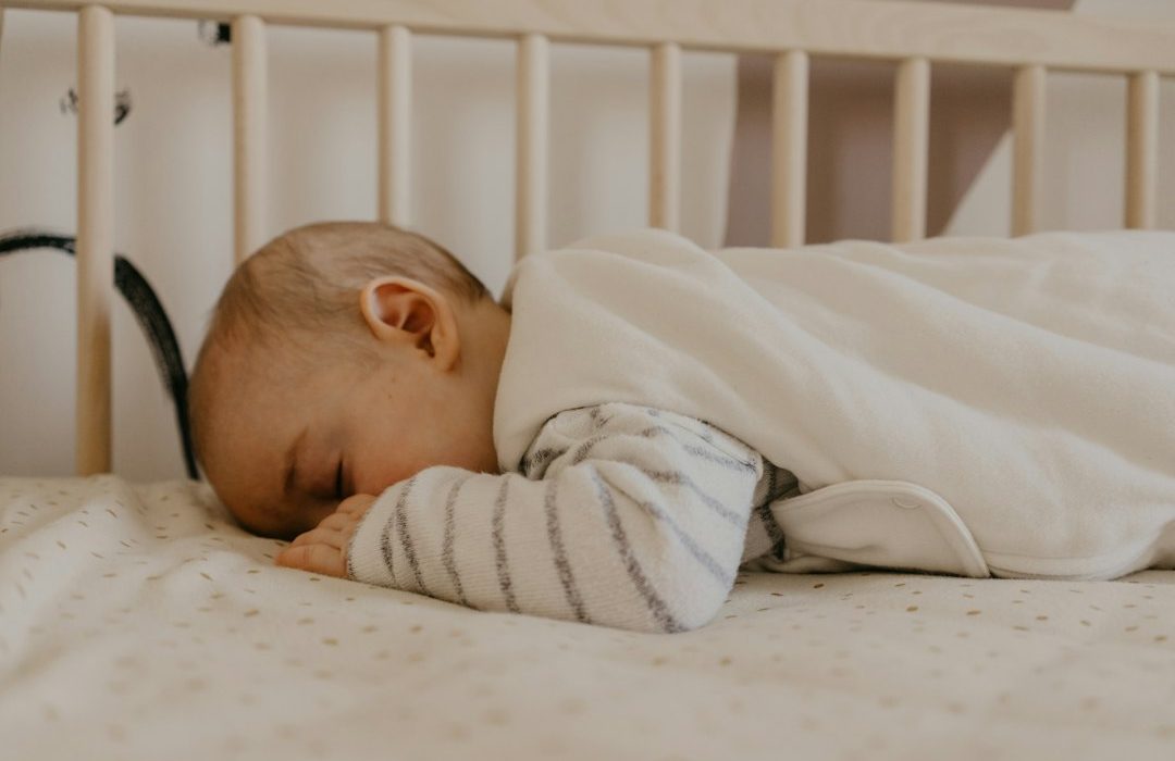a baby sleeping in a crib