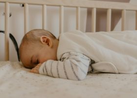 a baby sleeping in a crib